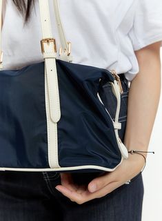 Product Detail Style : Casual Detail : Buckle Outer Shell Polyester 80 Polyurethane 20 / Lining Polyester 100 Color : Dark blue, Black, Beige Model Size Model is wearing size One Size and the color Dark blue. Height : 5'5" | 165cm / Top : S / Bottom : S (26 inch) .prddescription table, .prddescription td, .prddescription th { border : 1px solid black; border-collapse : collapse; padding: 10px; } Size(Inch) Size Width Height Depth String Height One Size 12.6" 8.3" 5.7" 10.8" - The measurement can Blue Nylon Shoulder Bag With Detachable Strap, Blue Nylon Shoulder Bag With Adjustable Strap, Navy Nylon Bags With Adjustable Strap, Blue Nylon Shoulder Bag With Double Handle, Blue Nylon Shoulder Bag With Zipper, Trendy Blue Nylon Shoulder Bag, Chic Blue Shoulder Bag For School, Large Capacity Navy Shoulder Bag, Bolero Sweater