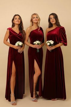 three women in long dresses standing next to each other and one has her leg high