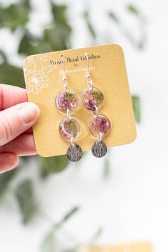 If you are looking for beautiful, handmade jewelry then these pressed flower dangle earrings will make your day! Our earrings are a perfect addition to any outfit. Our earrings will make the perfect gift! Please note that each pair of our earrings are made by hand. Some variations/imperfections are possible. /MEASUREMENTS *About 2.5 inches long /DETAILS *Silver Plated Stainless Steel; Hypoallergenic; NICKEL FREE *Real Pressed Flowers Nickel-free Botanical Flower Earrings, Botanical Birth Flower Dangle Earrings, Flower Dangle Earrings, Resin Earrings, Pressed Flower, Earrings Silver, Pressed Flowers, Jewelry Earrings Dangle, Silver Plate