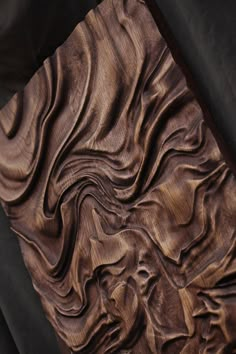 a piece of wood that has been carved to look like waves on it's surface