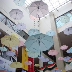 there are many umbrellas hanging from the ceiling