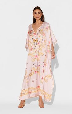 Gold, ornate filigree make a lovely resting place for a kaleidoscope of Butterflies and flowers in this blush pink long caftan. The flowing silhouette is constructed from our signature Polysilk fabric, reminiscent of the delicate movement a butterflies' wings take in flight. This long, floral caftan is suitable for everyday loungewear, dress-up, or something incredibly comfortable to sleep in. Printed long caftan Lusciously soft poly silk Lightweight and breathable Machine washable for easy care Spring Silk V-neck Kaftan, Spring Silk Kaftan With Kimono Sleeves, Feminine Silk Maxi Dress For Beach, Elegant Floral Print Flowy Kaftan, Elegant Maxi Length Daywear Kaftan, Pink Silk V-neck Maxi Dress, Elegant Pink Silk Kaftan, Spring Silk Kaftan, Floral Print Kaftan For Summer Wedding