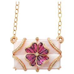 14K gold pink mother of pearl rhodolite special cut flower pendant necklace Elevate your elegance with our exquisite pendant crafted in 14 karat gold. The focal point is a stunning arrangement of four rectangular Pink Mother of Pearl pieces seamlessly joined into a single rectangle, creating a mesmerizing backdrop. At the heart of this masterpiece lies a delicate flower motif, formed by tapered baguette rhodolites channel-set into a four-petal design. Sparkling diamonds adorn the surface of both Elegant Pink Gold Necklace With Flower Pendant, Elegant Pink Mother Of Pearl Necklace, Elegant Pink Gold Flower Pendant Necklace, Exquisite Gemstone Flower Pendant Necklace, Luxury Pink Necklace With Pearl Pendant, Exquisite Pink Pendant Necklace, Luxury Pink Gold Gemstone Necklaces, Exquisite Pink Gemstone Necklaces, Exquisite Pink Gemstone Necklace