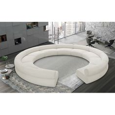 a white circular couch sitting on top of a rug