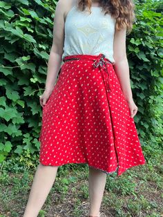 Are you in a blue floral mood or a red floral mood? With this reversible skirt from the 1970s, you can choose the color that suits your whims. It's like having two skirts in one!  This skirt does not have any labels and may have been homemade. It feels like cotton to me. So cute! Fits most similarly to a modern M. Since it's a wrap, it's very flexible and could likely work for a S or L as well. Please review measurements below.  Measurements Waist: 26-32 inches (adjustable) Length: 25.5 inches Condition: Excellent vintage condition. If you have any questions or need additional photos or measurements, please let me know. I'm happy to help! Thank you so much for shopping with Chloris Vintage. --Chandler Red Casual Wrap Skirt For Summer, Casual Red Wrap Skirt For Summer, Casual Red Flowy Wrap Skirt, Red Summer Wrap Skirt With Lining, Summer Red Fitted Wrap Skirt, Retro Red Summer Skirt, Fitted Red Wrap Skirt For Summer, Red Lined Flared Wrap Skirt, Red Relaxed Wrap Skirt For Spring