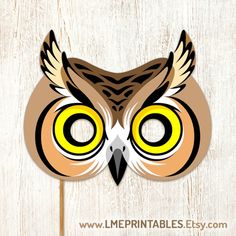 an owl mask with yellow eyes is on a wooden background and has the words printables easy