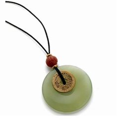 "This pendant features genuine jade and carnelian, with an antique reproduction brass I-Ch'ing coin. The pendant hangs on a waxed cotton cord. There is a knot closure at the top with a brass bead. Necklace measures 17\" long from the top of the cord to the bottom of the jade disc" Adjustable Jade Necklace For Good Luck, Vintage Waxed Cord Jewelry For Gifts, Adjustable Vintage Jade Necklace, Adjustable Vintage Jade Necklaces, Vintage Adjustable Jade Necklaces, Vintage Adjustable Jade Necklace, Vintage Adjustable Carnelian Necklace, I Ching, Carnelian Pendant