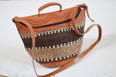 African sisal handbag handmade leather bag African inspired fashion accessories gift Size - 10'' by 10'' Adjustable strap Woven Leather Satchel For Daily Use, Leather Woven Satchel For Daily Use, Handmade Leather Straw Bag For Travel, Woven Leather Shoulder Bag For Market, Leather Woven Shoulder Bag For Market, Handmade Leather Straw Bag For Daily Use, Handwoven Leather Shoulder Straw Bag, Handwoven Leather Straw Shoulder Bag, Woven Leather Satchel In Natural Color