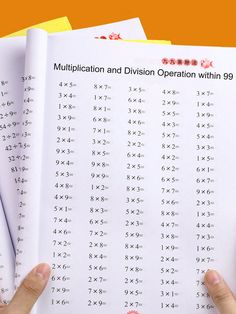 two hands are holding an open book with numbers on it and the title is multiplication and division operation within 99