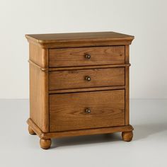 a small wooden dresser with three drawers