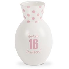 a white vase with pink polka dots and the number sixteen on it's side