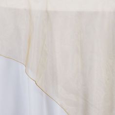 a white table cloth with gold trim on it