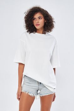 This oversized white shirt is the perfect blend of comfort and style. Its relaxed fit and trendy design make it a versatile piece that can be dressed up or down. Soft, Breathable Comfort Crafted from soft, breathable material, this shirt is perfect for all-day wear. A Versatile Wardrobe Staple Pair it with jeans, shorts, or a skirt for a casual, effortless look. It's also great for layering under a jacket or cardigan. The Perfect Gift Looking for a thoughtful gift? This shirt is a great choice. Trendy Everyday Shirt With Shirttail Hem, Casual Boxy Top With Shirttail Hem, Oversized Everyday Summer Tops, Oversized Tops For Everyday Summer Wear, Oversized Cotton Top With Shirttail Hem, Plain Tops For Summer Streetwear, Oversized Summer Tops For Everyday, Relaxed White Tops With Shirttail Hem, Relaxed White Top With Shirttail Hem