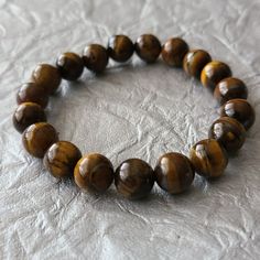 Tiger Eye Stone Beaded Bracelet-Gemstone Bracelet-Healing Stone Material: Tiger Eye Stone Dimension: 6.5 In Length New Without Tag Amber Gemstone Beaded Bracelets With Round Beads, Amber Beaded Bracelets With Natural Stones, Brown Gemstone Beads Crystal Bracelet For Healing, Brown Crystal Bracelet With Gemstone Beads For Healing, Brown Gemstone Bracelets For Healing, Amber Round Beaded Bracelets With Natural Stones, Brown Gemstone Healing Bracelets, Brown Gemstone Beaded Bracelets, Amber Round Beads Bracelet For Meditation