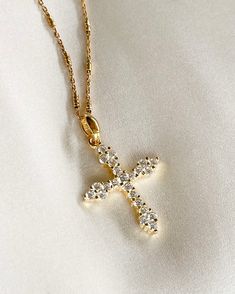 The Luxe Cross Necklace adds that perfect touch of brilliance to your look, and layers perfectly with other gold necklaces. Cross pendant is 14K gold plated silver with Cubic Zirconia, on rolo gold filled chain. Pendant: 19x25mm & 2.5mm thick. All items come in a gift box ready to gift. To see more please visit  https://www.etsy.com/shop/BijouLimon Bijou Limon jewelry collections present a romantic French spin on the latest jewelry trends. Based on the US West Coast but French at heart, Bijou Li Dazzling Gold Necklace, Spiritual Gold Crystal Necklaces For Layering, Dainty Gold Necklace With Jewels, Elegant Gold Crystal Necklaces For Layering, Elegant Gold Crystal Necklace For Layering, Elegant 14k Gold-filled Cross Pendant Necklace, Delicate Gold Jeweled Necklaces, Dazzling Gold Pendant Necklace, Delicate Gold Necklace With Jewels