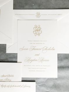 the wedding stationery is laid out on top of each other, with matching envelopes