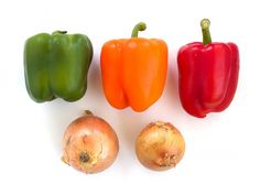 four peppers and three onions on a white background