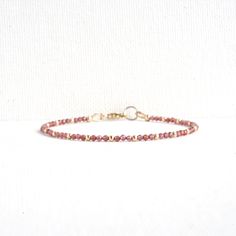 Red Garnet Dainty Bracelet Finished with a lobster claw clasp. *BRACELET LENGTH- 6.5 - 8.0 Inches* * MATERIALS & DIMENSIONS *  * Red Garnet Beads: about 2.0 mm - Grade AAA  * Gold Filled or Sterling Silver Beads: about 2.0 mm * Silver or Gold Filled Findings * Premium Strong Flexible Beading Wire *Arrives in a gift box* Choose Your Bracelet Length Use a tape measure. Wrap the tape measure around the wrist on which you plan to wear your bracelet. Make a note of the number at the point where the t Adjustable Red Jewelry With Lobster Clasp, Adjustable Burgundy Bracelets, Adjustable Burgundy Bracelet, Black Onyx Bracelet, Garnet Bracelet, Dainty Bracelet, Clasp Bracelet, Onyx Bracelet, Minimalist Bracelet