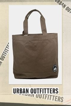 the urban outfitters tote bag is made from canvas and features an emblem on the front