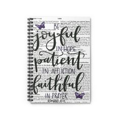 a spiral notebook with the words be joyful in hope and an image of a butterfly