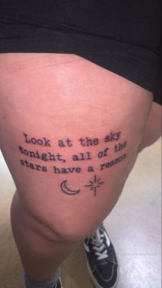 a person with a tattoo on their leg that says look at the sky tonight, all of the stars have a reason