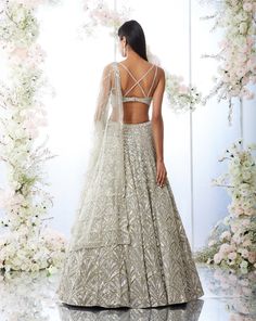 This lehenga set features platinum cut sequin and crystal embellishment in a cascade motif pattern. The ensemble is paired with a criss-cross back and fully embroidered net dupatta.From Seema Gujral's Tuscan Summer collection. DELIVERY TIMEPlease allow 8-12 weeks for your outfit to arrive. FABRIC DETAILSNet Professional cleaning only. Crystal Lehenga, Seema Gujral, Sangeet Outfit, Lehenga Designs Simple, Traditional Indian Dress, Motif Pattern, Indian Gowns Dresses, Traditional Indian Outfits, Indian Lehenga