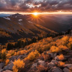 the sun is setting over mountains with trees in the foreground