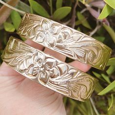 This beautiful Heirloom bracelet features the plumeria flower  with scroll design. It is heavy weight so it will keep its shape. These bracelets are of excellent quality Hamilton gold plated and are tarnish resistant. Hamilton Jewelry, Hawaiian Heirloom Jewelry, Hawaiian Bracelets, The Bangles, Bangle Gold, Hawaiian Jewelry, Heirlooms Jewelry, Gold Armband, Dainty Bracelet