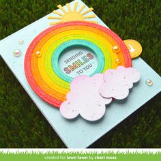 a card with a rainbow on the grass and some words that say smile to you