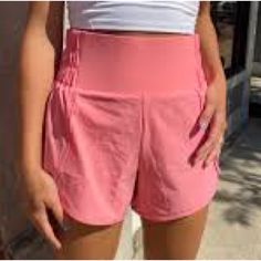 These Highwaisted Running Shorts Are Functional But Still Fashionable, Featuring Scalloped Detail On The Side, Inner Lining, And A Partially Ruched Waistband Detail. Perfect For Heading To The Gym, Running Errands, Or A Casual Day Out. Super Cute And Comfy!, Nwt Pink/Coral Fits True To Size Inner Lining Partially Ruched Waistband Size Small Inseam: 3.75" Self: 88% Nylon, 10% Spandex Inner Lining: 80% Polyester, 20% Spandex Machine Wash Cold | Tumble Dry Low Summer Training Bottoms With Built-in Shorts, High Waist Bottoms With Built-in Shorts For Running, Athletic Bottoms With Built-in Shorts For Sports, Sportswear Bottoms With Built-in Shorts, Sporty Running Bottoms With Built-in Shorts, Comfortable Gym Activewear With Built-in Shorts, Casual Activewear With Built-in Shorts For Spring, Sporty Bottoms With Built-in Shorts And Athletic Fit, High Waist Moisture-wicking Gym Shorts