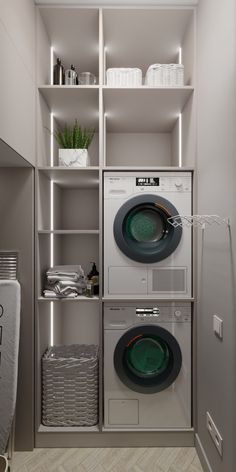 a washer and dryer in a small room with shelves above the washer