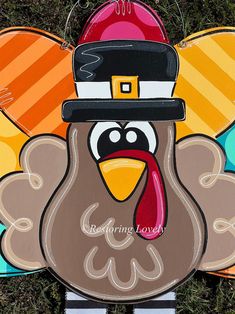 a turkey with a top hat on it's head is standing in the grass