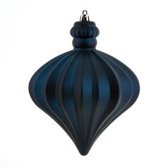 a blue ornament hanging on a white wall