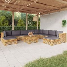 an outdoor living area with couches and tables