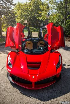 a red sports car with its doors open