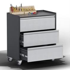 three drawers are stacked on top of each other in front of a file cabinet with pens and pencils