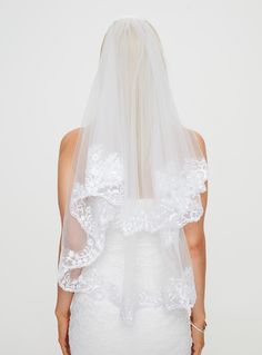 the back of a woman wearing a white veil