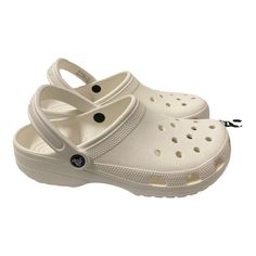 Comfortable And Stylish, The Crocs Classic Clog Is A Must-Have In Your Closet! It Features Light Construction And A Pivoting Heel Strap For A Secure Fit. Water-Friendly And Lightweight, This Clog Is Easy To Clean And Dries Quickly. It’s Perfect For Daily Activities. Comfortable White Clogs For Beach, Comfortable White Clogs For The Beach, Comfortable White Beach Clogs, White Non-slip Clogs For The Beach, White Non-slip Clogs For Beach, White Closed Toe Beach Clogs, White Closed Toe Clogs For Beach, White Closed Toe Casual Mules, Comfortable White Round Toe Mules