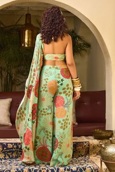 Mint green flared pant with floral print. Comes with padded one shoulder draped blouse embellished by sequins. - Aza Fashions Green Fitted Pant Set For Wedding, Fitted Green Pant Set For Wedding, Green Palazzo Set For Summer Festive Occasions, Fitted Green Pant Set For Party, Green Fitted Pant Set For Party, Summer Festive Green Palazzo Set, Festive Green Fitted Pant Set, Fitted Green Bollywood Pant Set, Green Sharara For Spring Party