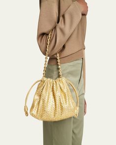 Loewe "Flamenco" shoulder bag in fringe metallic napa leather     Chain top handle     Shoulder strap    Can be worn as a top handle or shoulder bag     Ruched drawstring and magnetic closures    Approx. 7.8"H x 11.7"W x 4.1"D    Made in Spain Gold Shoulder Bag With Braided Handles For Formal Occasions, Modern Gold Bucket Bag For Evening, Formal Gold Shoulder Bag With Braided Handles, Modern Gold Evening Bucket Bag, Evening Woven Leather Crossbody Bucket Bag, Evening Woven Leather Bucket Bag Tote, Evening Woven Leather Bucket Bag, Gold Bucket Bag With Detachable Handle For Evening, Woven Leather Bucket Shoulder Bag For Evening