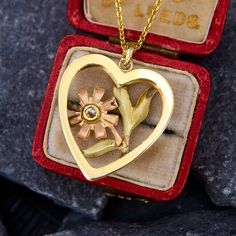 This beautiful 14k yellow gold necklace features a 1940s heart shaped pendant with a beautiful flower set with an old European cut diamond in the center.  The flower is a rosier gold while the heart and foliage are a yellower toned gold.  The pendant hangs from a modern 118 inch long cable chain with jump rings so it can be worn at 16 or 17 inches as well. Vintage Heart Necklace For Mother's Day, Vintage Open Heart Jewelry For Mother's Day, Vintage Yellow Gold Heart Charm Necklace, Vintage Yellow Gold Heart Necklace, Vintage Yellow Gold Heart Necklace For Valentine's Day, Vintage Heart Necklace For Mother's Day Anniversary, Vintage Gold Necklaces With Flower Shape, Vintage Necklace With Flower Pendant, Vintage Hallmarked Flower Pendant Necklace