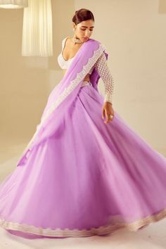 Lilac attached cancan organza lehenga with pearl embellished waistband and hem. Comes with sweetheart neck pearl drop full sleeve, padded blouse and a dupatta.
Pearl drops on sleeves
Lehenga length: 46 inches
Note:
Kindly contact customer service to add the hanging tassel at the back at an additional cost.
Outfit worn by the other model on the front is not for sale.
Occasion: Destination Wedding - Aza Fashions Organza Anarkali Set With Unstitched Blouse For Wedding, Wedding Anarkali Set With Unstitched Blouse In Organza, Purple Lace Work Dupatta For Wedding, Organza Lehenga With Sheer Dupatta For Wedding, Organza Dress With Dori Work For Wedding, Wedding Lehenga With Sheer Dupatta In Organza, Elegant Purple Organza Lehenga, Organza Wedding Dress With Dori Work, Elegant Purple Lehenga For Wedding