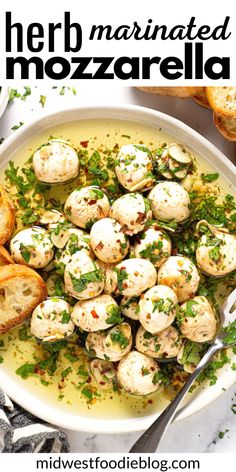 a white bowl filled with bread and topped with mozzarella sauce, garnished with parsley