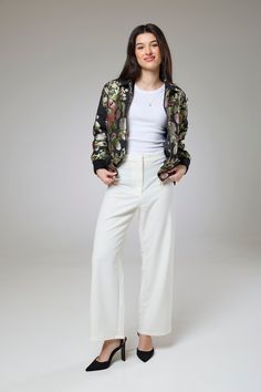 Flora Heaven Bomber Jacket  Our Flora Heaven Bomber Jacket, a heavenly fusion of botanical charm and contemporary style. This divine piece from our Bomber Jacket collection is designed to envelop you in the enchanting beauty of nature while elevating your look with its modern silhouette.  The bomber jacket silhouette offers a versatile canvas for the floral motif, with ribbed cuffs and hem adding a touch of urban edge. Whether paired with jeans for a casual day out or layered over a dress for ev Chic Floral Print Formal Outerwear, Chic Long Sleeve Blazer With Floral Embroidery, Chic Floral Print Outerwear For Work, Luxury Spring Outerwear With Floral Embroidery, Chic White Outerwear With Floral Embroidery, Elegant Floral Embroidered Outerwear For Work, Elegant Floral Embroidered Outerwear For Spring, Jacket Silhouette, Jacket Collection