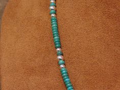 "Beautiful vintage sterling silver turquoise bead necklace. The necklace measures 20\" long from end to end. It has small silver beads in between the turquoise stones. IT comes together with a small silver hook. This is a stunning blue/green turquoise bead necklace! Please let me know if you have any questions and thank you for looking! % NK-2" Green Turquoise Round Bead Necklace In Sterling Silver, Turquoise Necklace With Sterling Silver Clasp And Round Beads, Turquoise Necklace With Round Beads And Sterling Silver Clasp, Green Turquoise Round Beads Necklace In Sterling Silver, Green Turquoise Beaded Necklace In Sterling Silver, Green Turquoise Necklace With Round Beads In Sterling Silver, Turquoise Beaded Necklaces With Sterling Silver Clasp, Turquoise Necklace With Round Silver Beads, Turquoise Necklace With Round Gemstone Beads In Sterling Silver