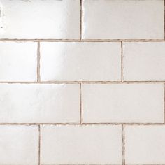 a white tiled wall with no grout