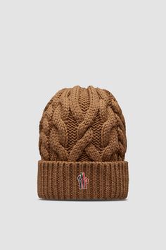 Taking you from the slopes to the city streets, this wool beanie is designed with warmth in mind. The heavy knit is part of the Moncler Grenoble collection. Winter Wool Cable Knit Hat, Wool Cable Knit Hats For Cold Weather, Winter Wool Knitted Beanie, Knitted Wool Beanie For Winter, Cozy Brown Wool Beanie, Wool Knitted Beanie For Cold Weather, Wool Knitted Beanie Cap, Knitted Wool Beanie For Cold Weather, Knitted Wool Beanie Cap