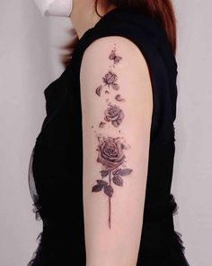 a woman with a rose tattoo on her arm