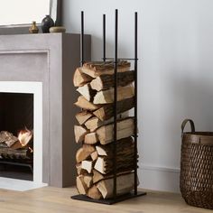 a stack of logs sitting next to a fire place