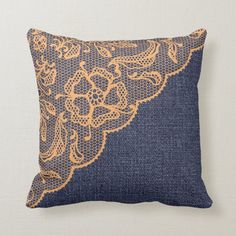 a blue pillow with an orange lace design